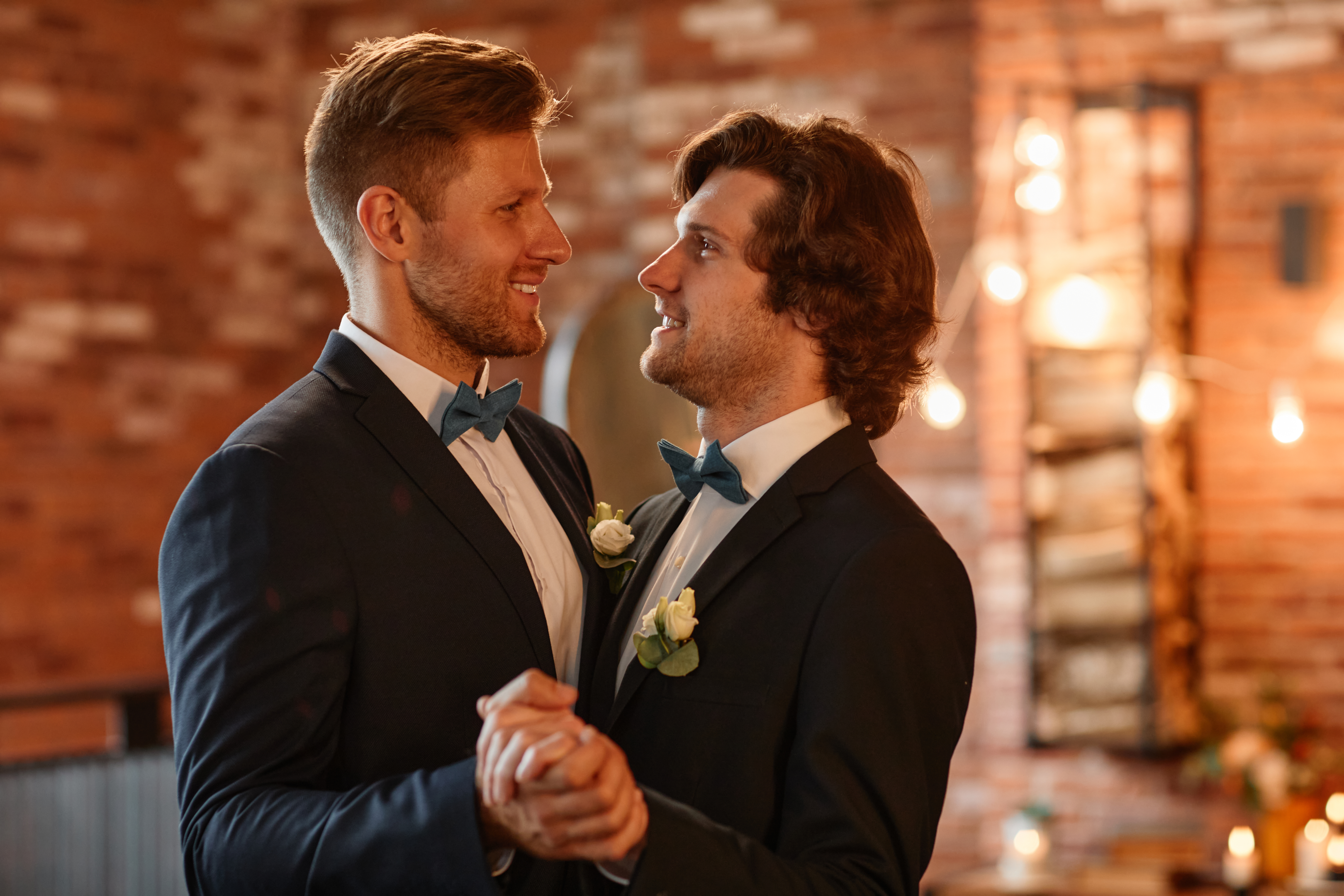 "Same-sex couple celebrating their union, emphasizing the importance of setting up wills and trusts to protect their future together."