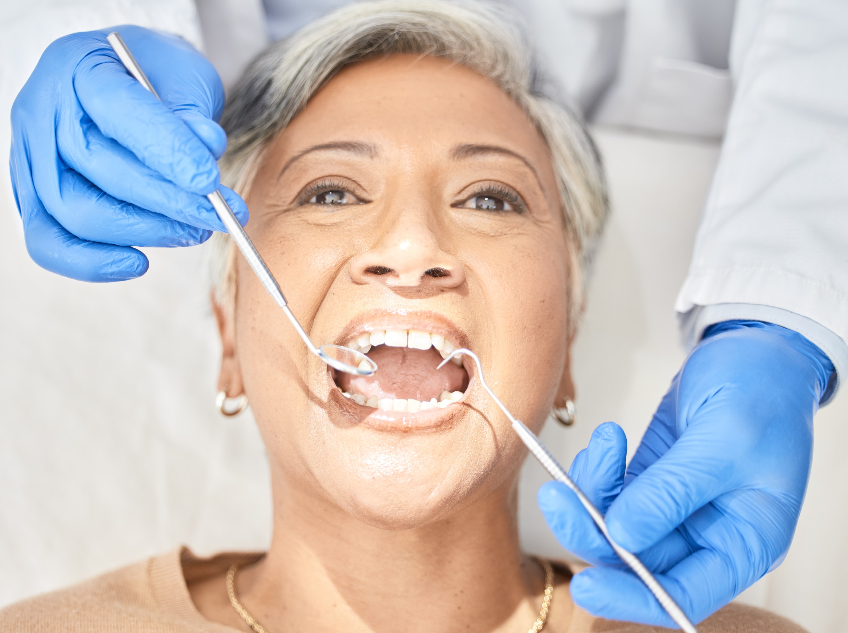 Woman at oral surgery office getting a tooth examination