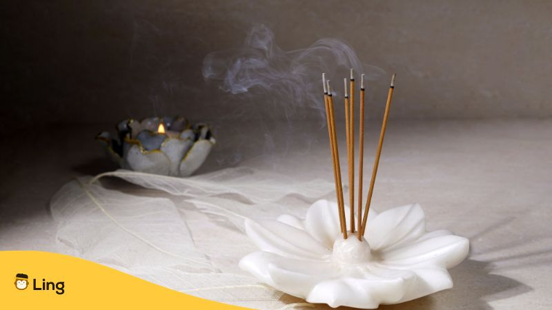Smoke from Burning Incense Sticks Standing on Lotus Incense Holder