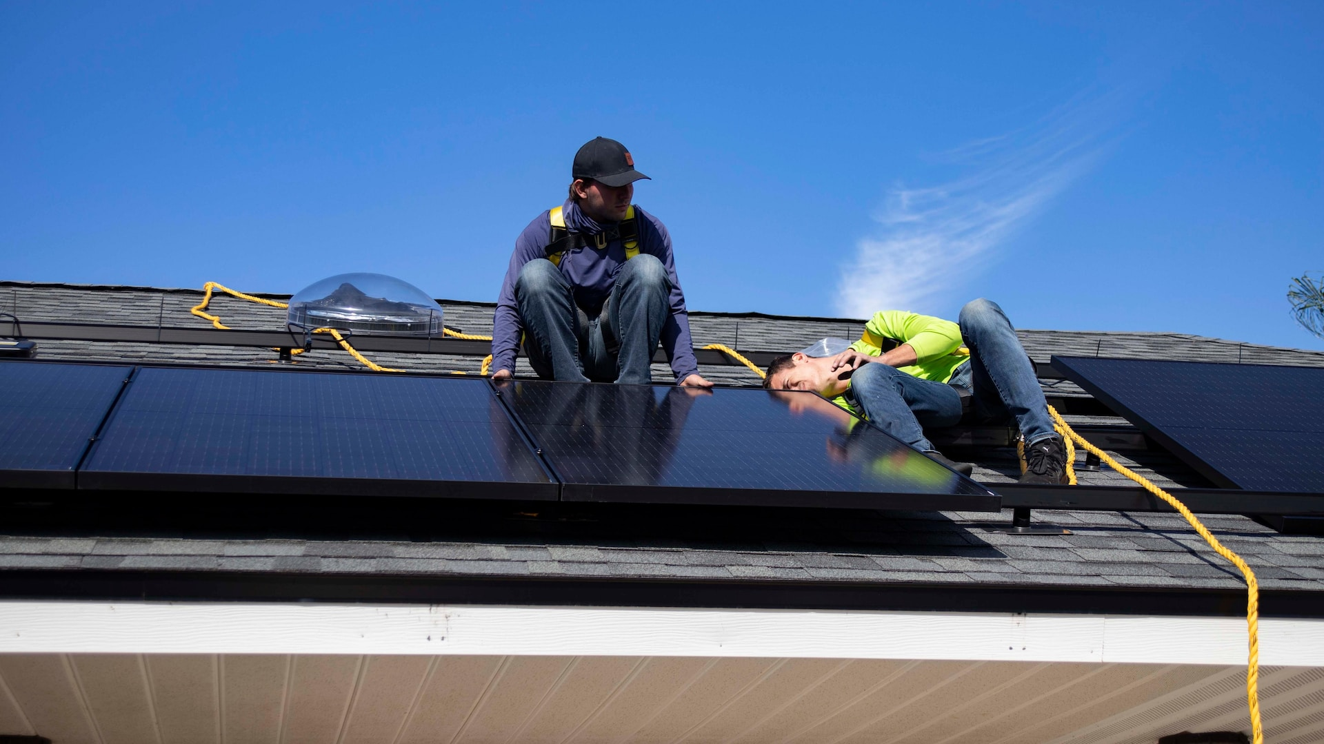 A local company installing solar panels on a roof.