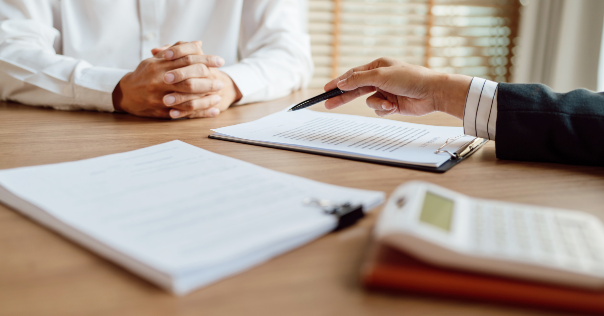 Attorney discussing settlement documents and compensation with a client after an Uber accident.