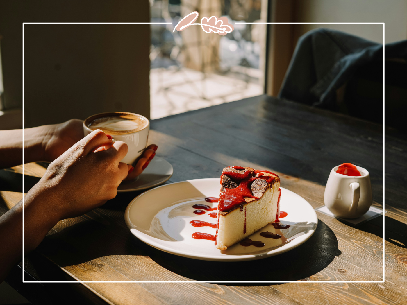 Hands holding a cup of coffee next to a plate with a slice of cheesecake drizzled with strawberry sauce with table mountain in the backd. Fabulous Flowers and Gifts