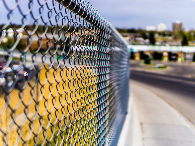 An image showing various types of chain link fences for security and boundary definition.