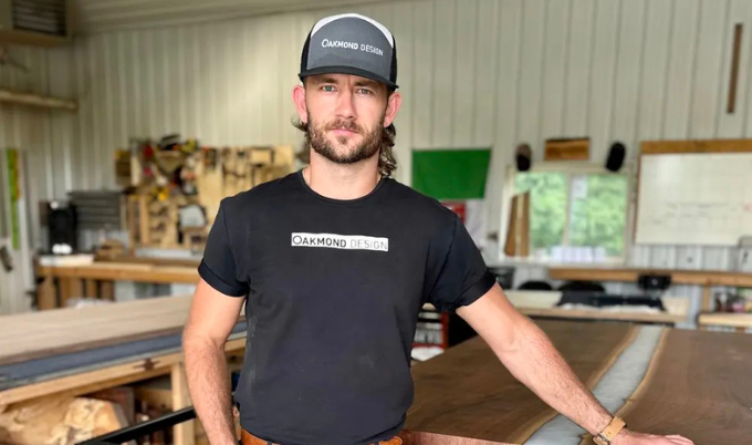 Clay standing in his workshop, where he makes his own lumber as opposed to buying timber. 