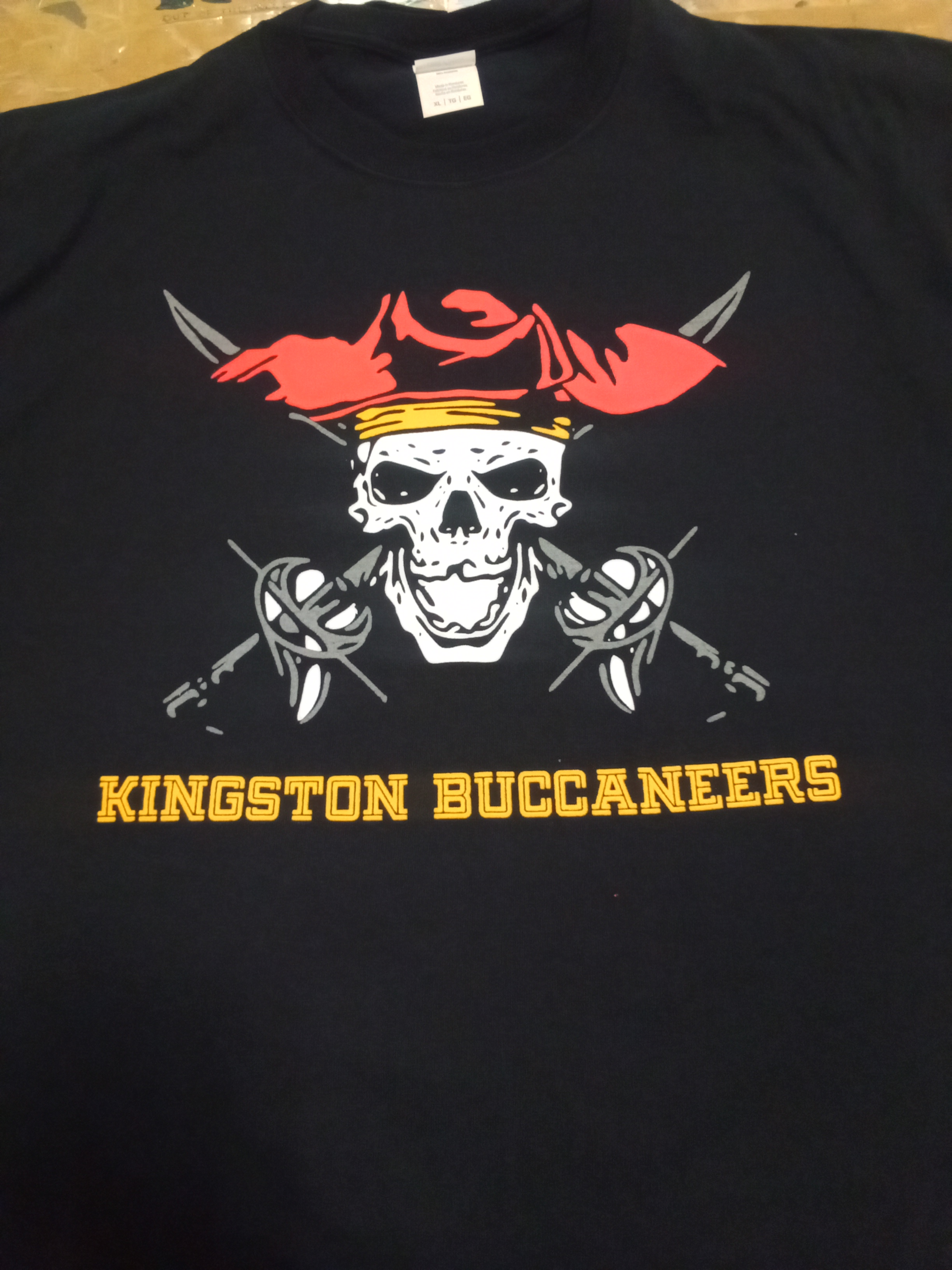 A printed pirate-themed logo on a classic black t-shirt