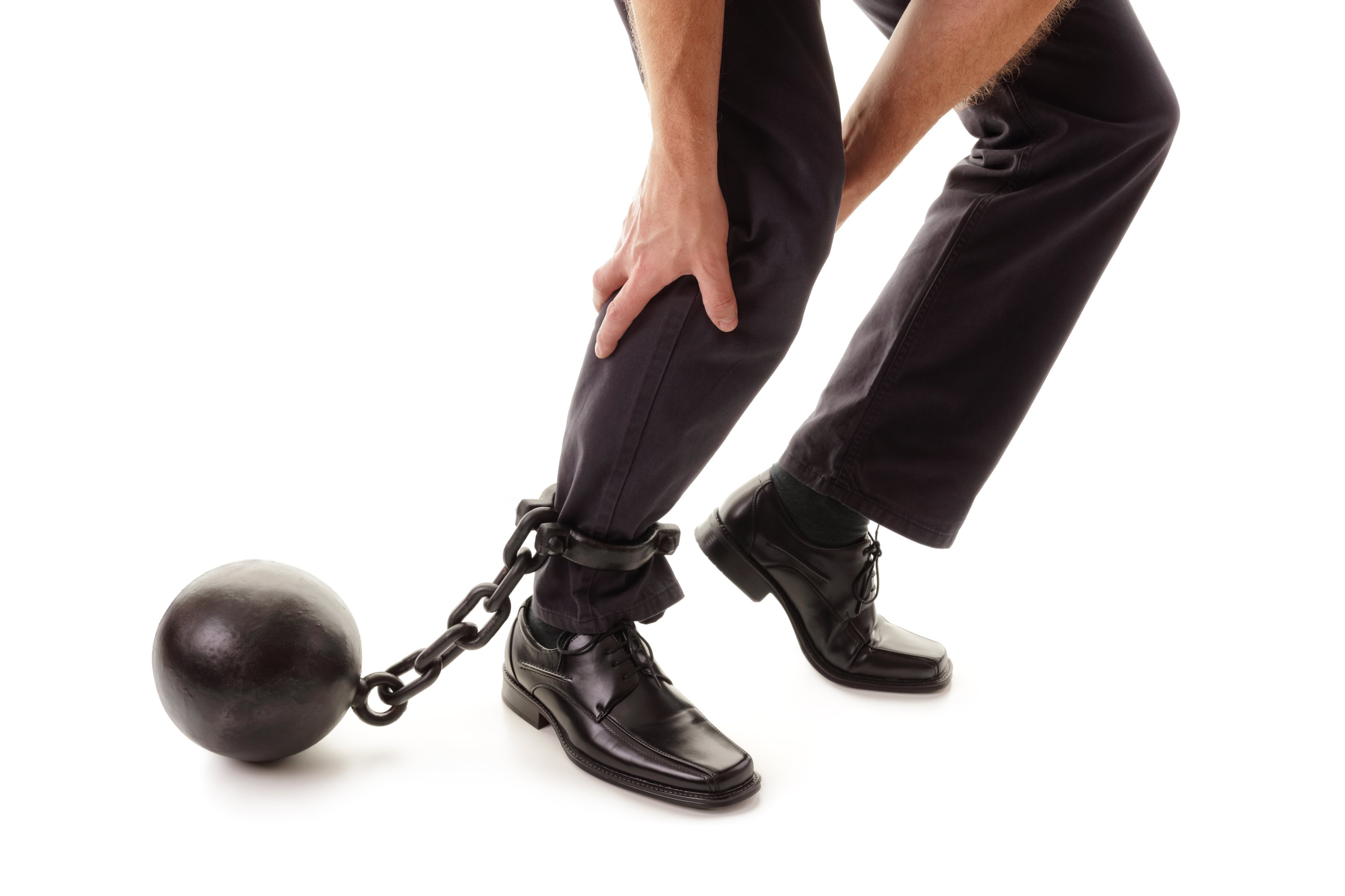 ball and chain on someone's ankle signifying tax liability to the Internal Revenue Service