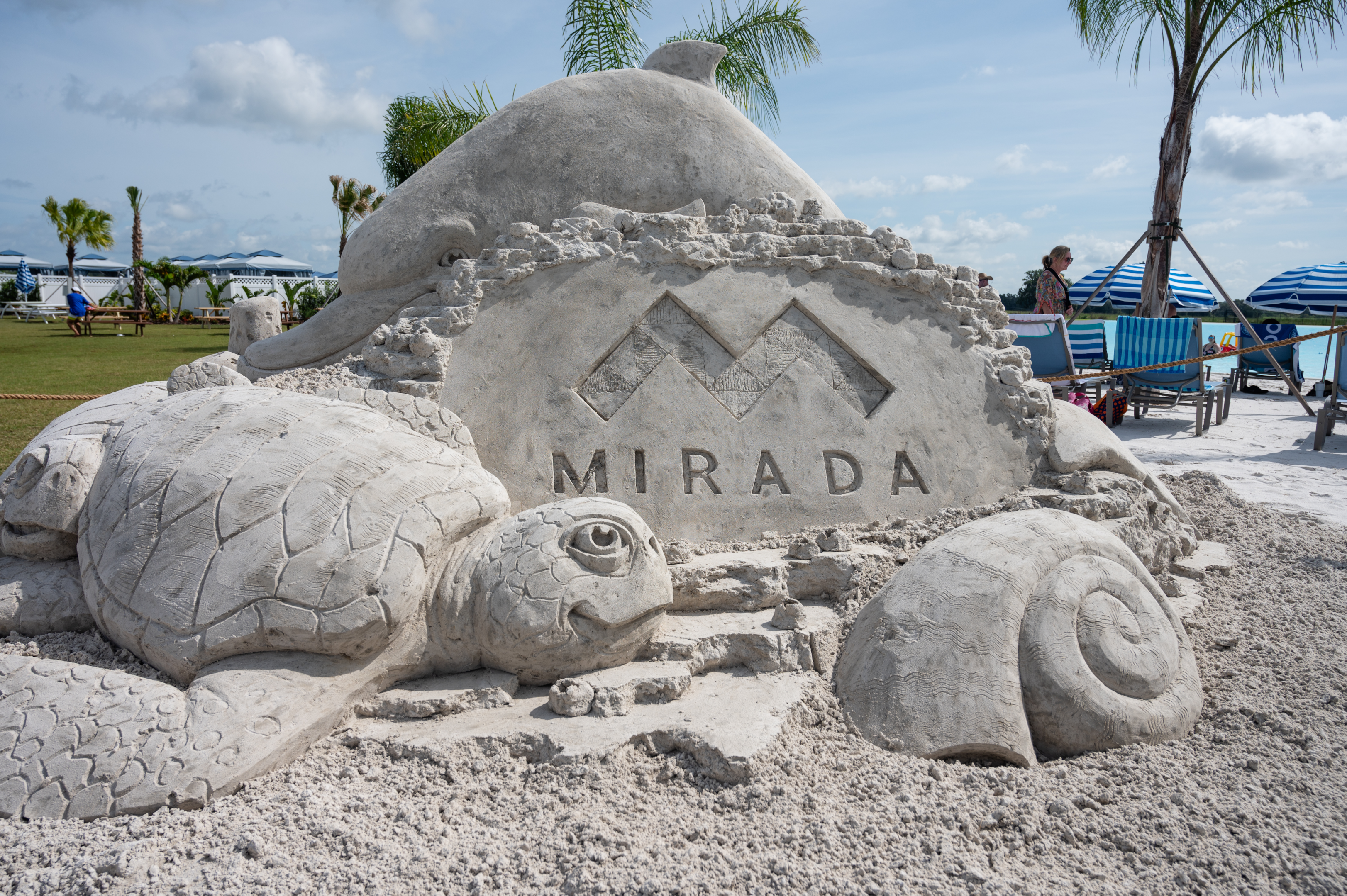 A sand sculpture form Sandtastic Sand featuring a sea shell and turtle with the Mirada logo