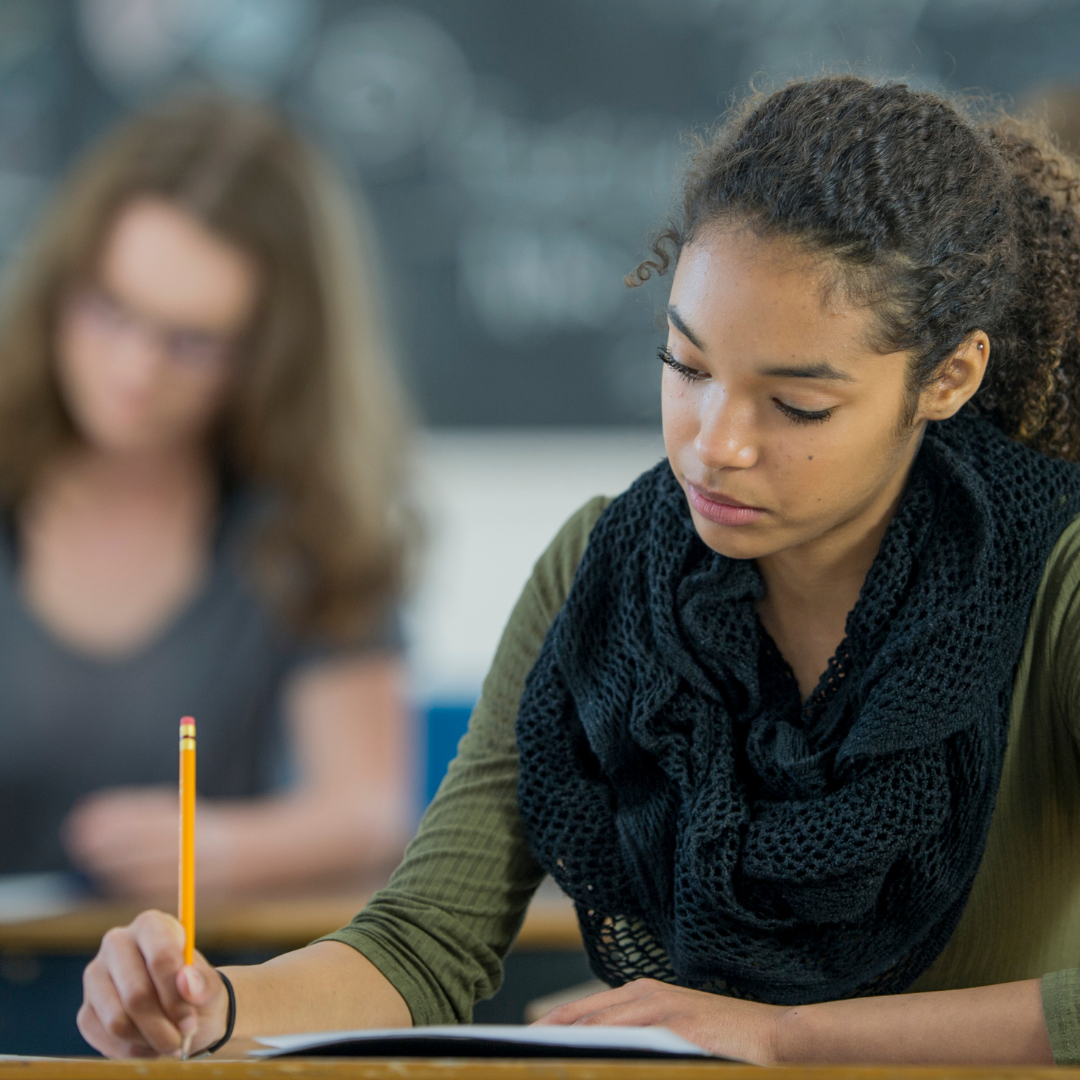 Girl taking an exam in a classroom