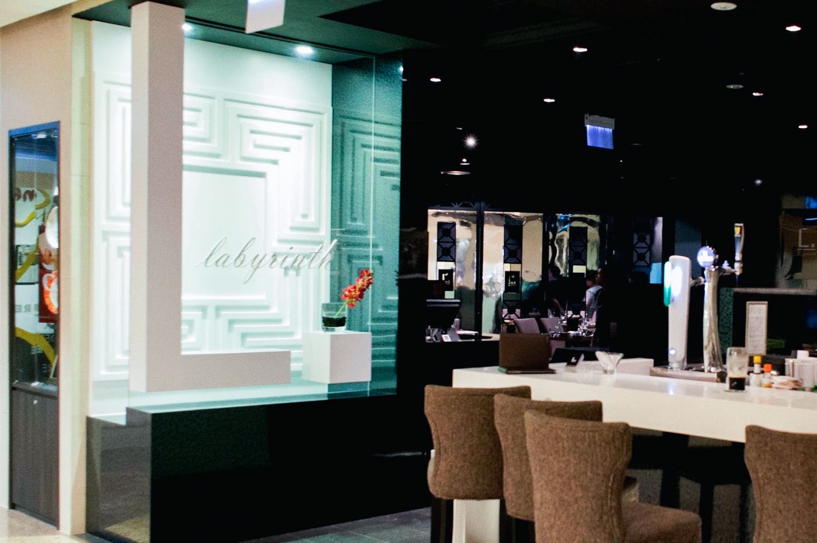 Modern restaurant featuring Labyrinth branding and elegant seating.