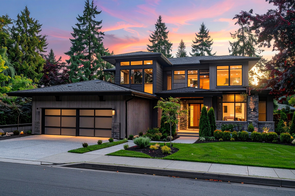 Exterior view of a modern home in Truckee, highlighting a wide driveway and an expansive garage.