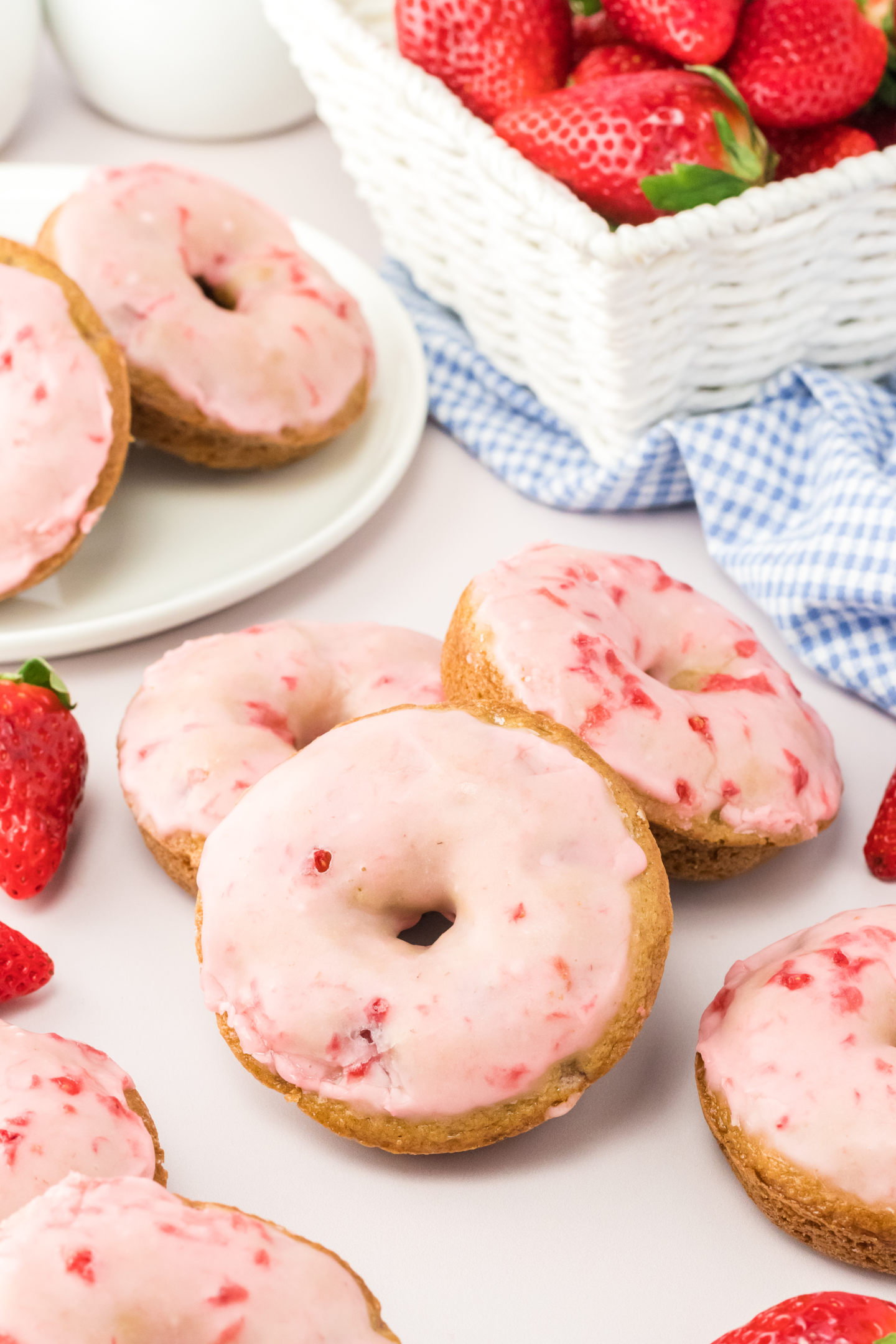 baked strawberry doughnuts topped with pink powdered sugar glaze