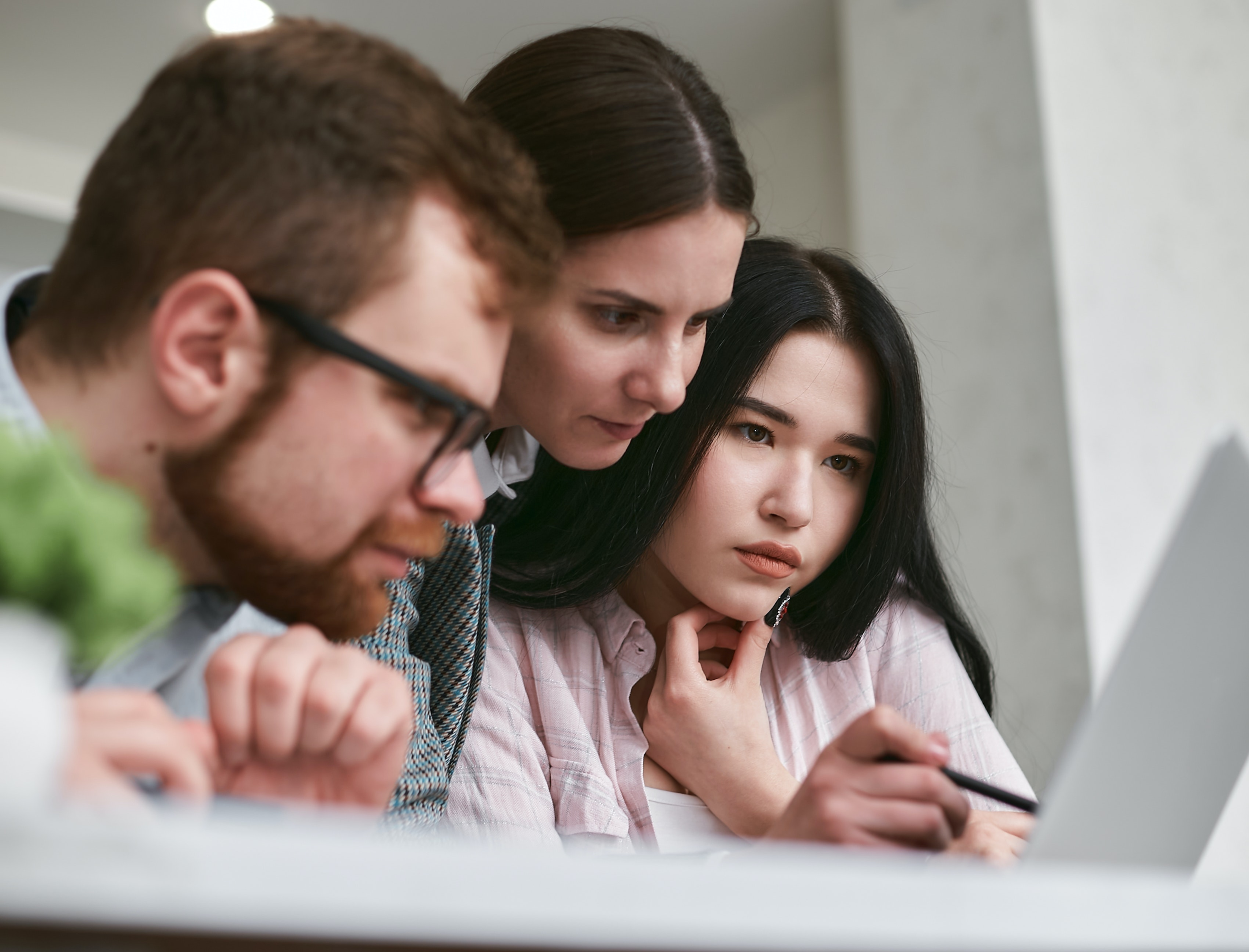 teacher and students looking at a laptop