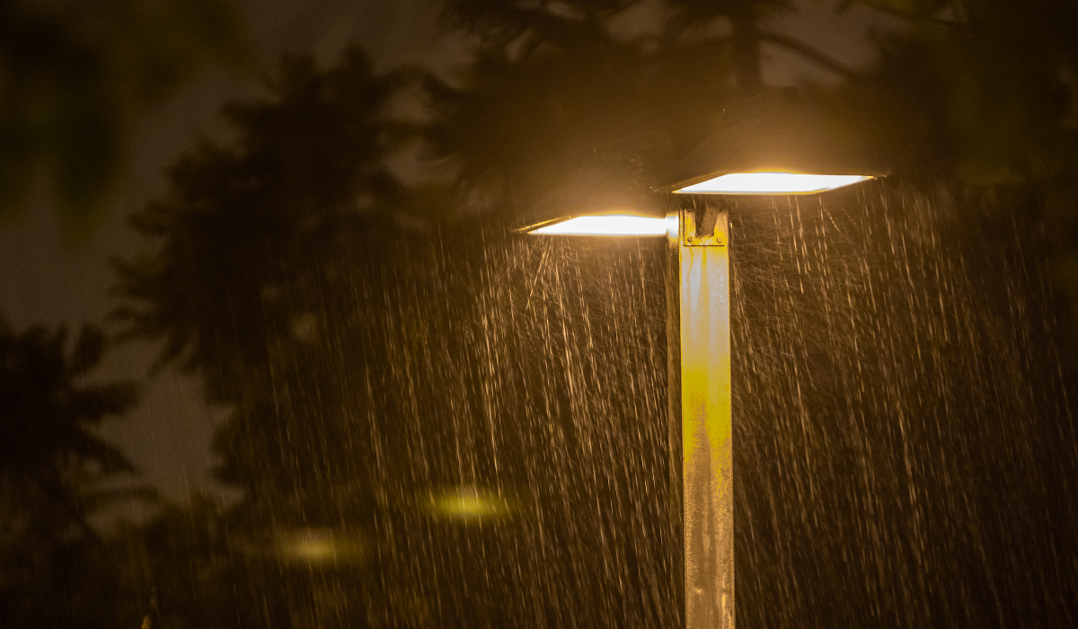Flood lights on a pole in the rain at night