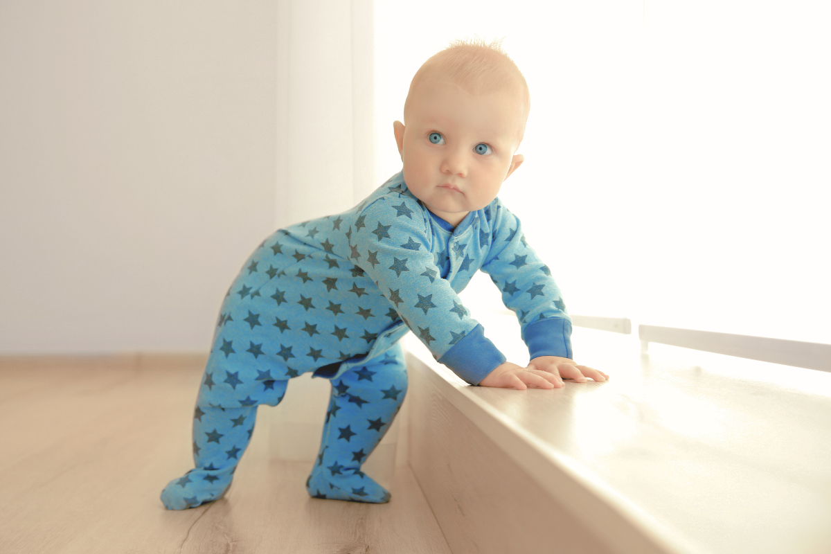 Baby pulling himself up on stairs. Poppyseed Play