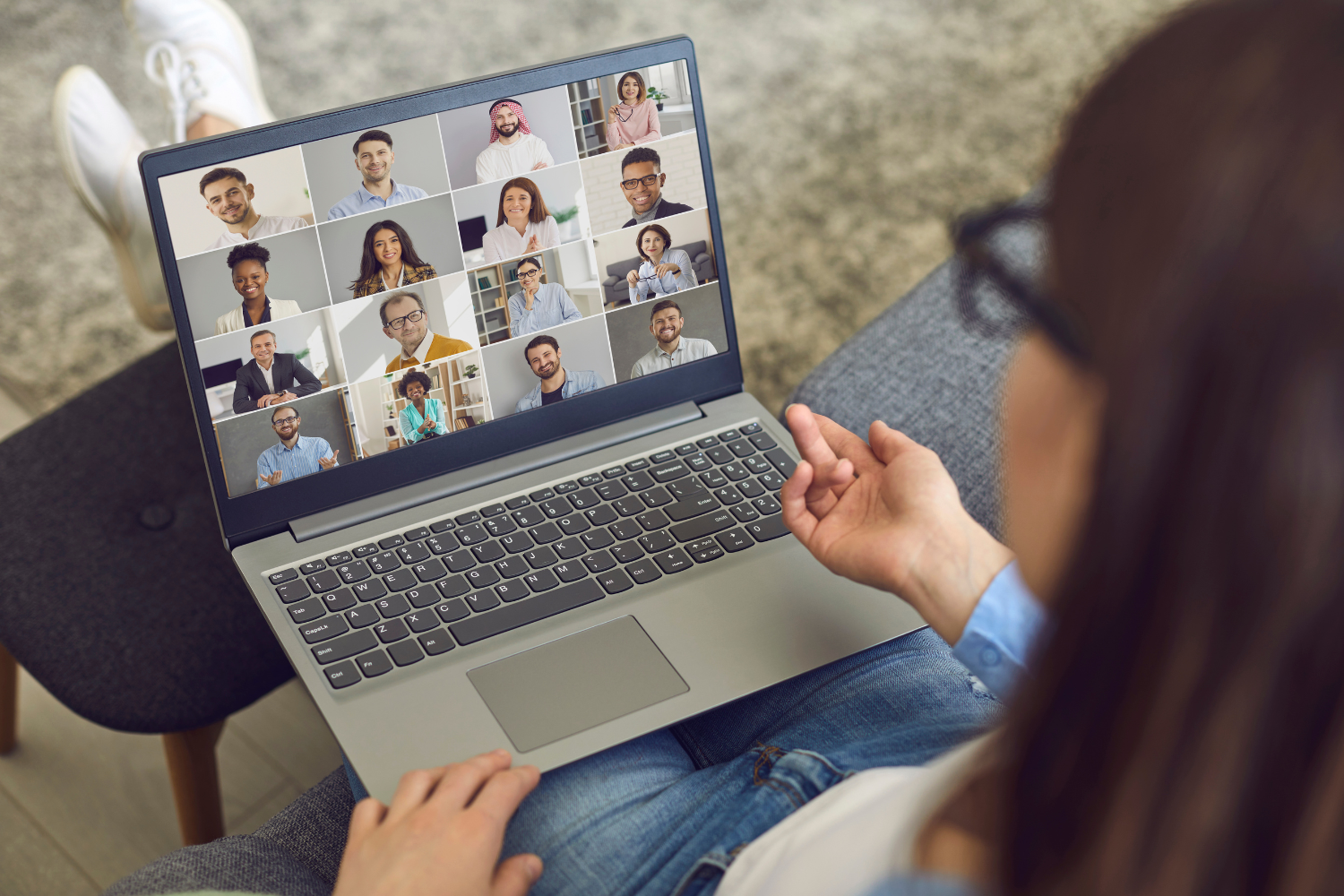 Diverse remote team members smiling on a video call.