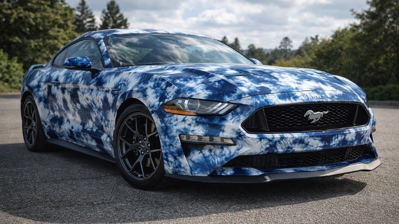 A Mustang wrapped in blue tie n die vinyl wrap