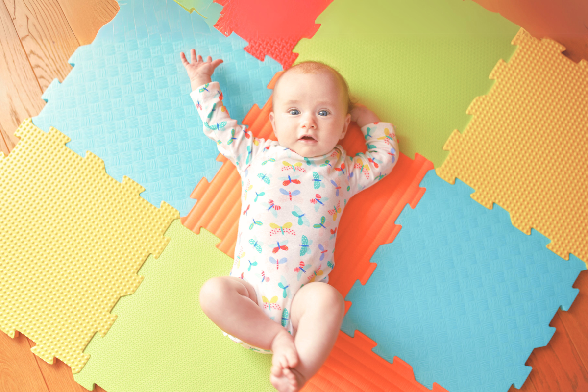 Baby laying on foam mat