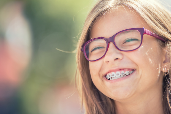 young girl living with braces during her whole overbite treatment