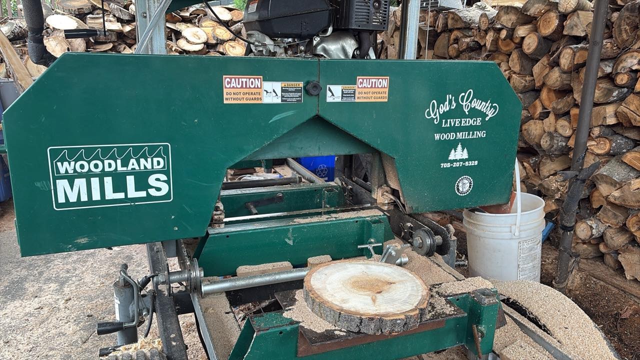 A Woodland Mills portable sawmill making wood crafts from a log.