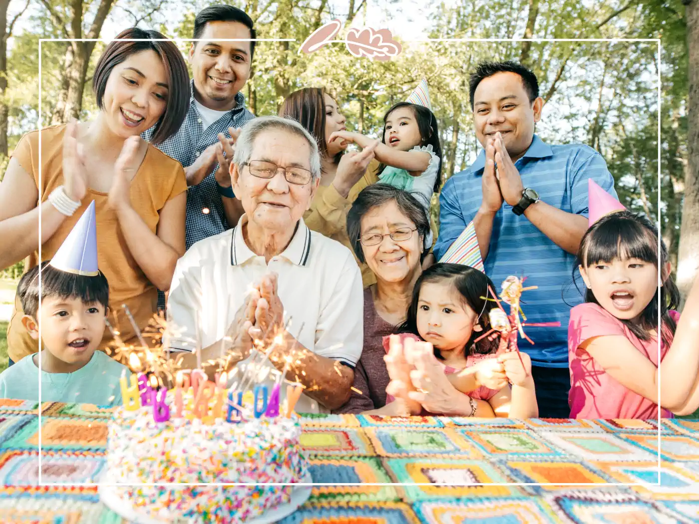 A multi-generational family celebrating a birthday outdoors with a birthday cake. Wishing you a day filled with happy birthday wishes. Beautiful moments with Fabulous Flowers and Gifts.