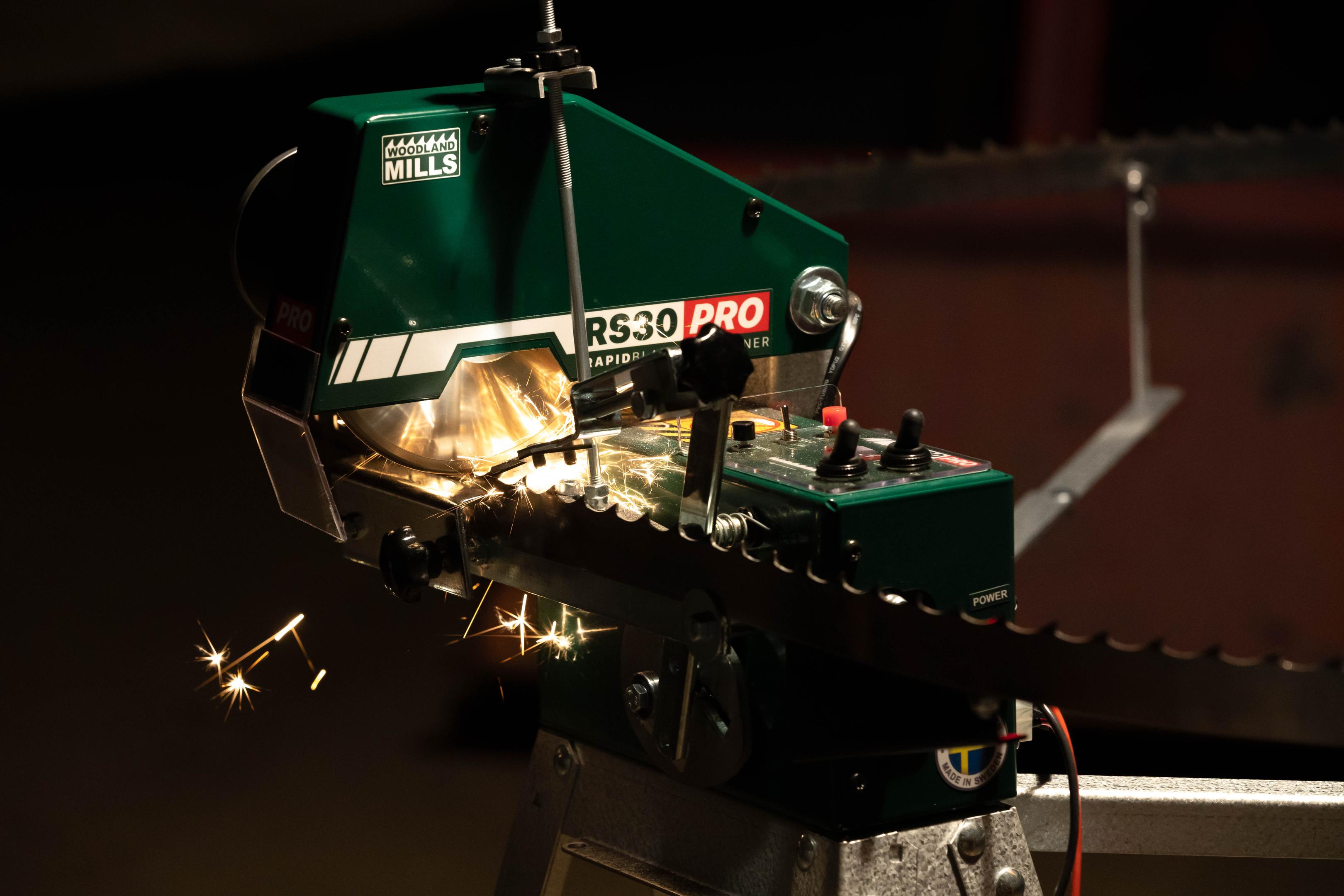 A bandsaw being sharpened on a Woodland Mills RS30 PRO Bandsaw Blade Sharpener.