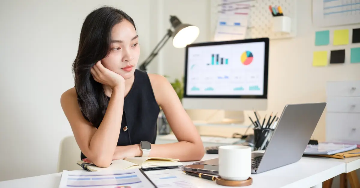 How do I change the name of my LLC? A woman prepares business documents for LLC name change.