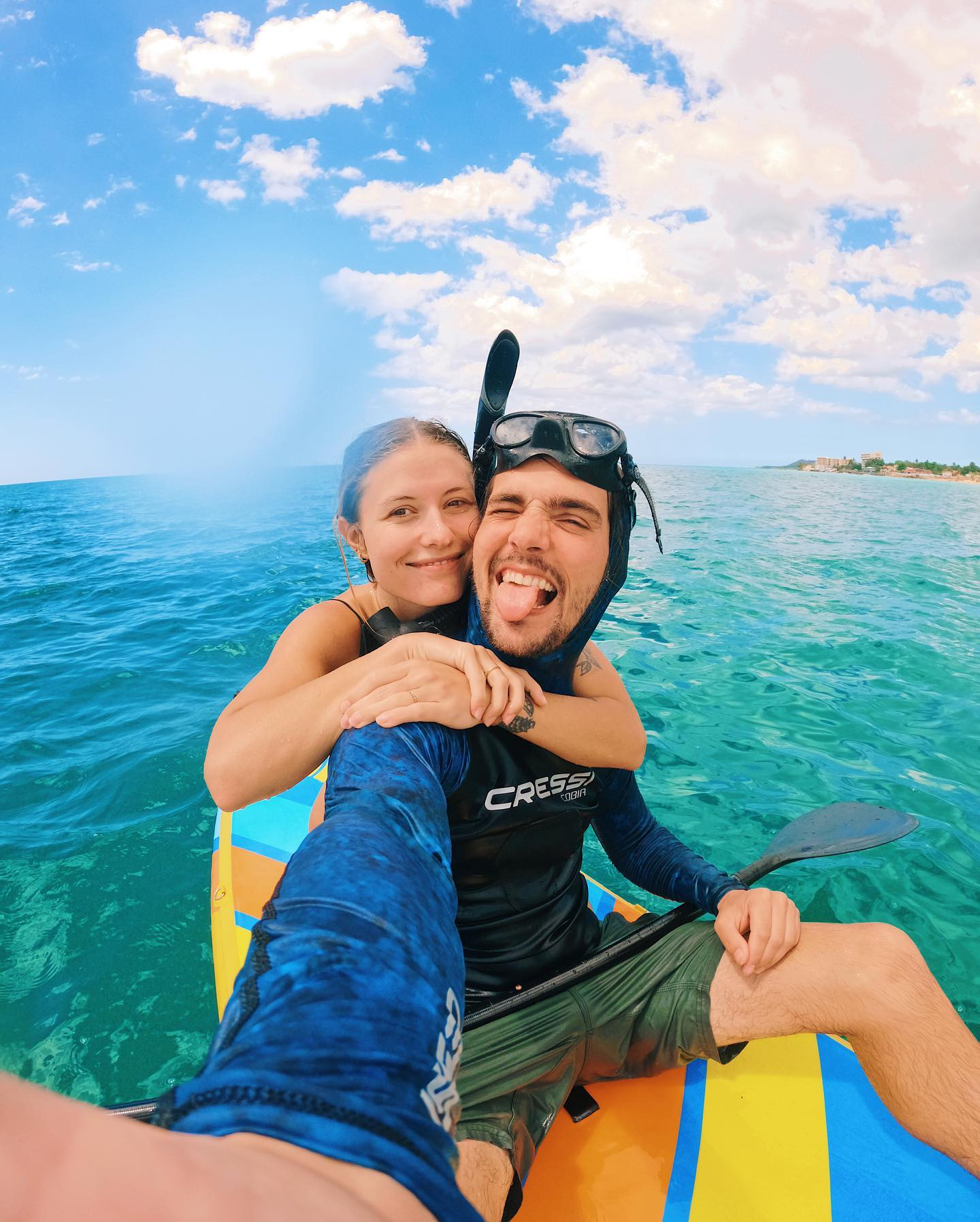 snorkelers on an inflatable paddle board