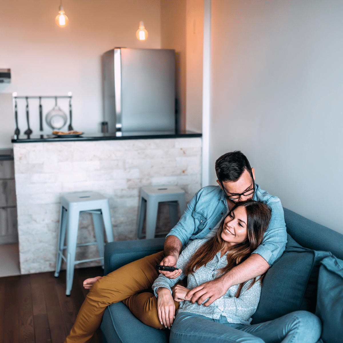 Man and woman on couch, kissing: Featured In How Does A Virgo Man Test You