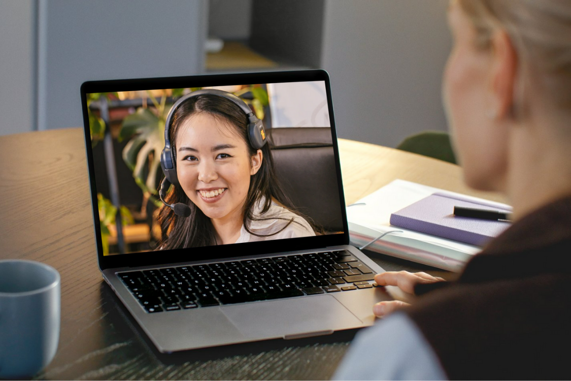 Online interview with a Filipino remote worker using a headset and laptop