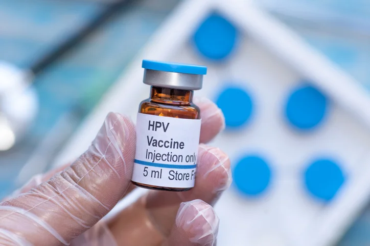 A person holding a HPV vaccine vial