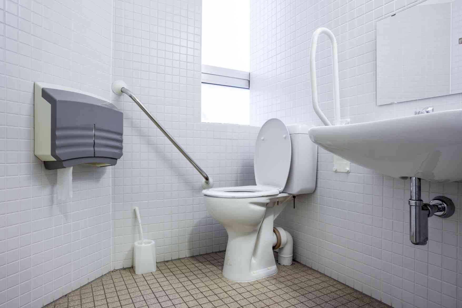 Accessible bathroom with grab bars and safety features for fall prevention.