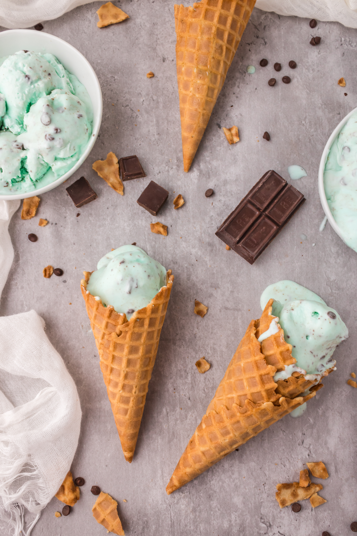 mint chocolate chip ice cream cones laying on counter