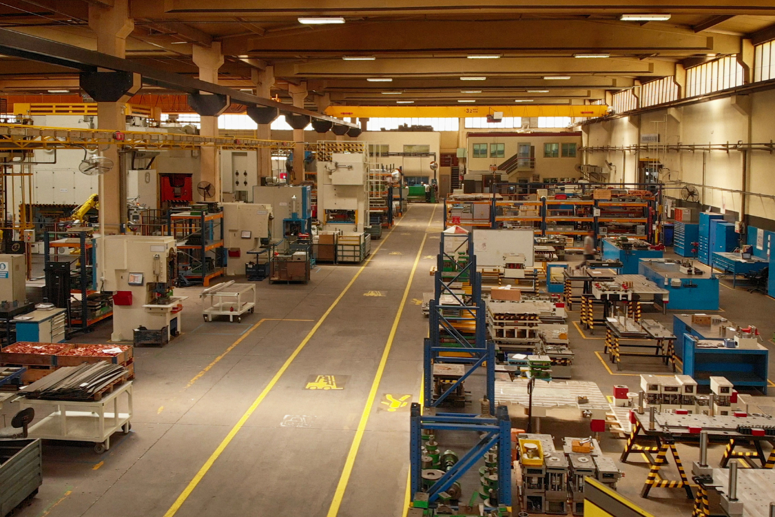 Interior of a supplement manufacturing facility with production equipment and workstations