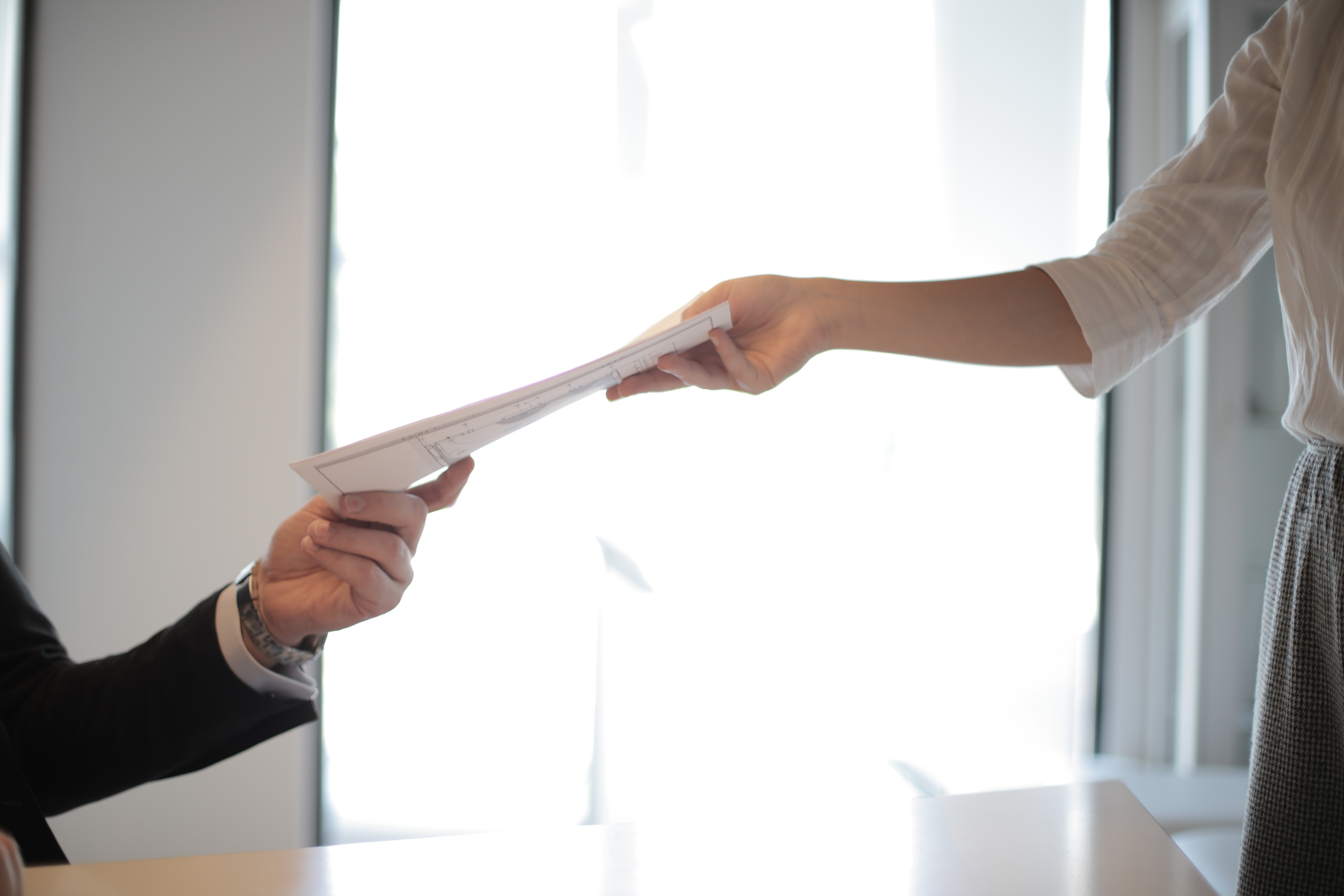 a woman handing application forms