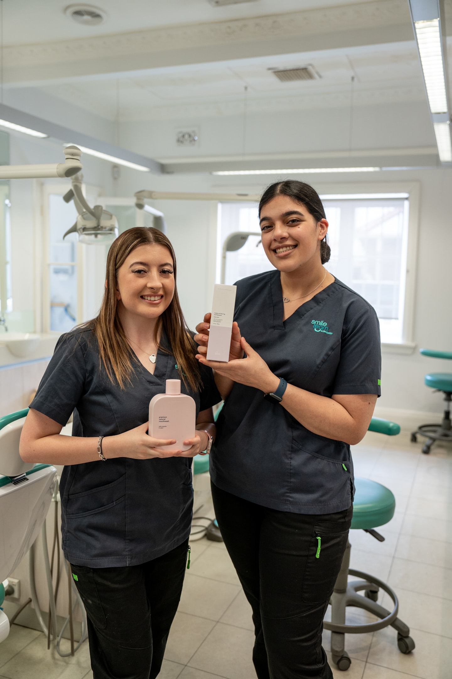 Two young nurses holding Gem oral hygiene 