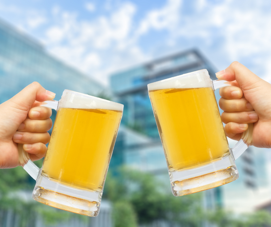                             A person looking at a glass of beer, celebrating their success in quitting alcohol