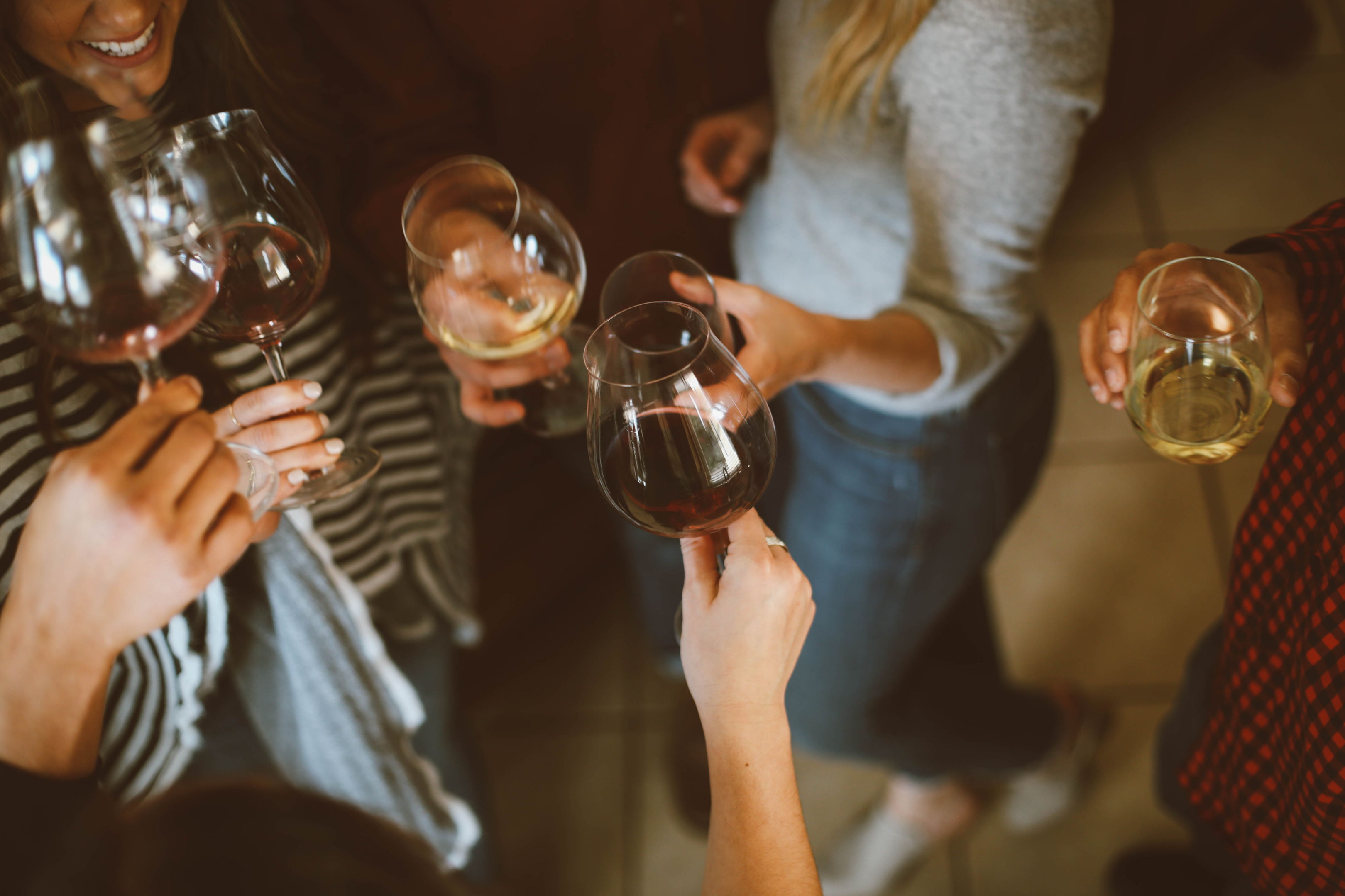 ALT: Group photo of people tossing wine glass. | IMG LINK: https://images.unsplash.com/photo-1519671482749-fd09be7ccebf?ixlib=rb-1.2.1&ixid=MnwxMjA3fDB8MHxwaG90by1wYWdlfHx8fGVufDB8fHx8&auto=format&fit=crop&w=870&q=80