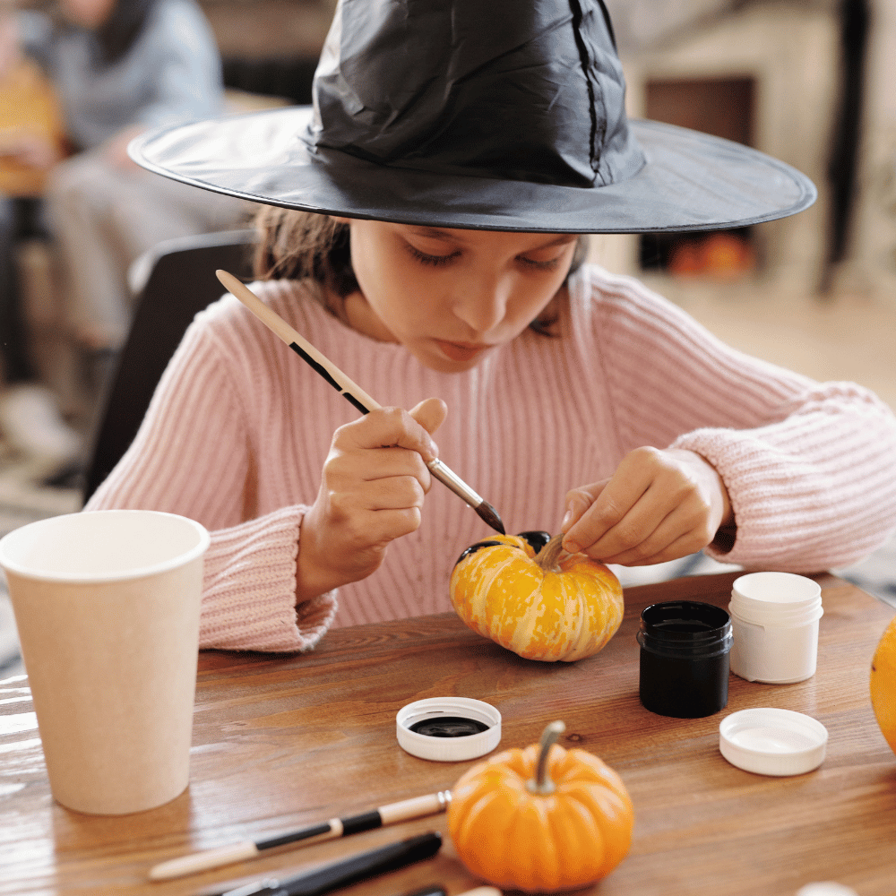 A person painting a pumpkin