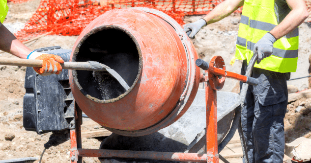 A cement mixer being cleaned and maintained
