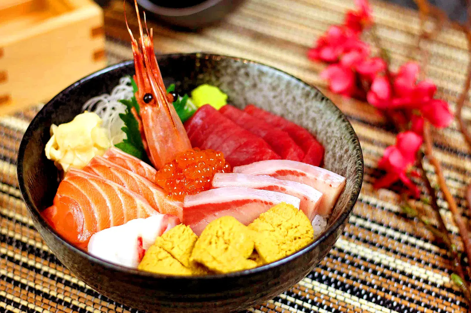 Chirashi don bowl with assorted sashimi, salmon, tuna, prawns, ikura, and Japanese seafood toppings