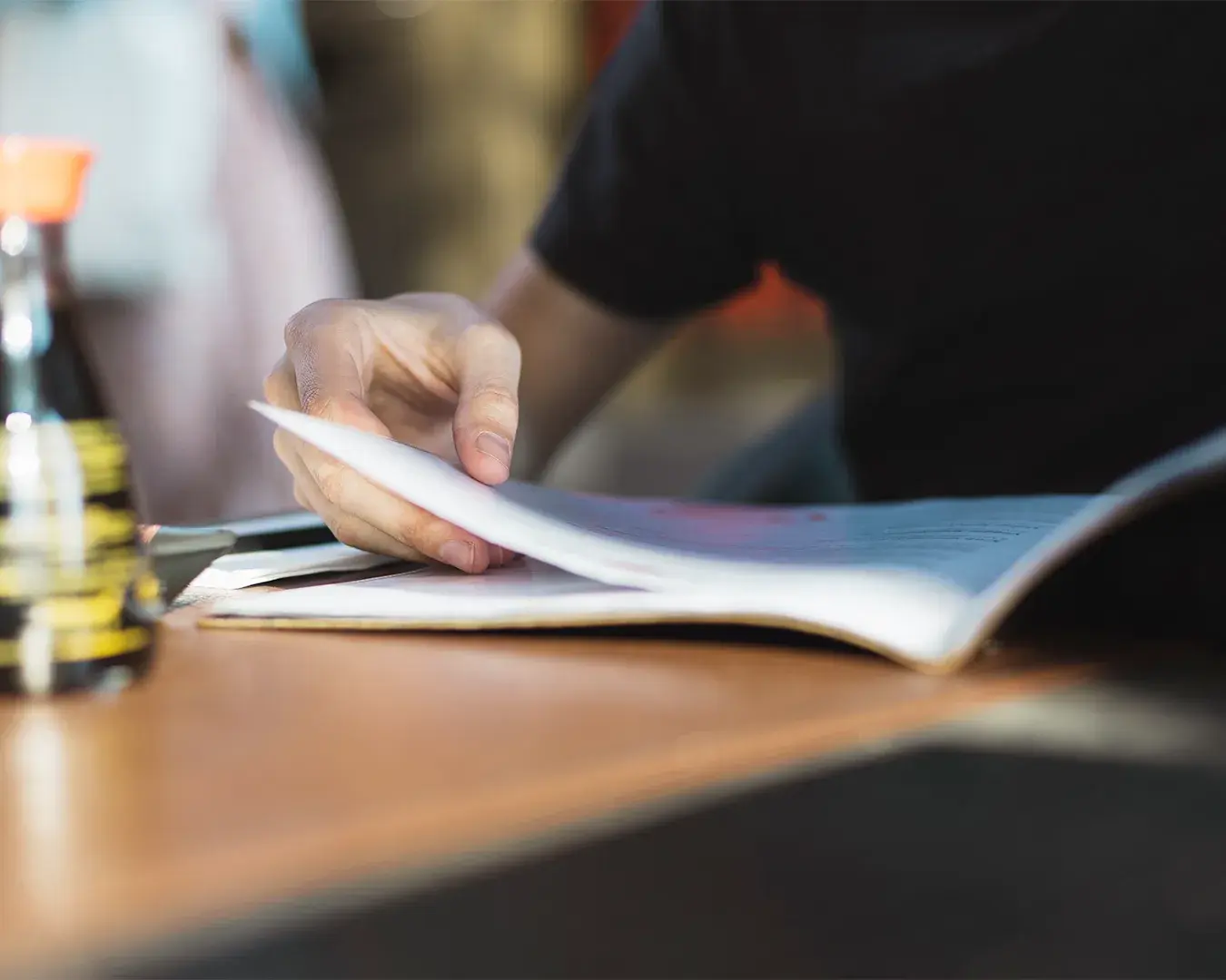 Restaurant owner reviewing a menu or sales report at a table