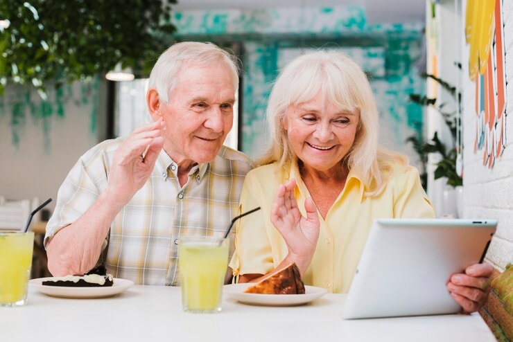 Old couple saying goodbye to a videocall