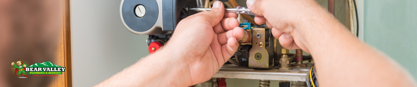 A technician working on a heating system blower motor and flame sensor. 