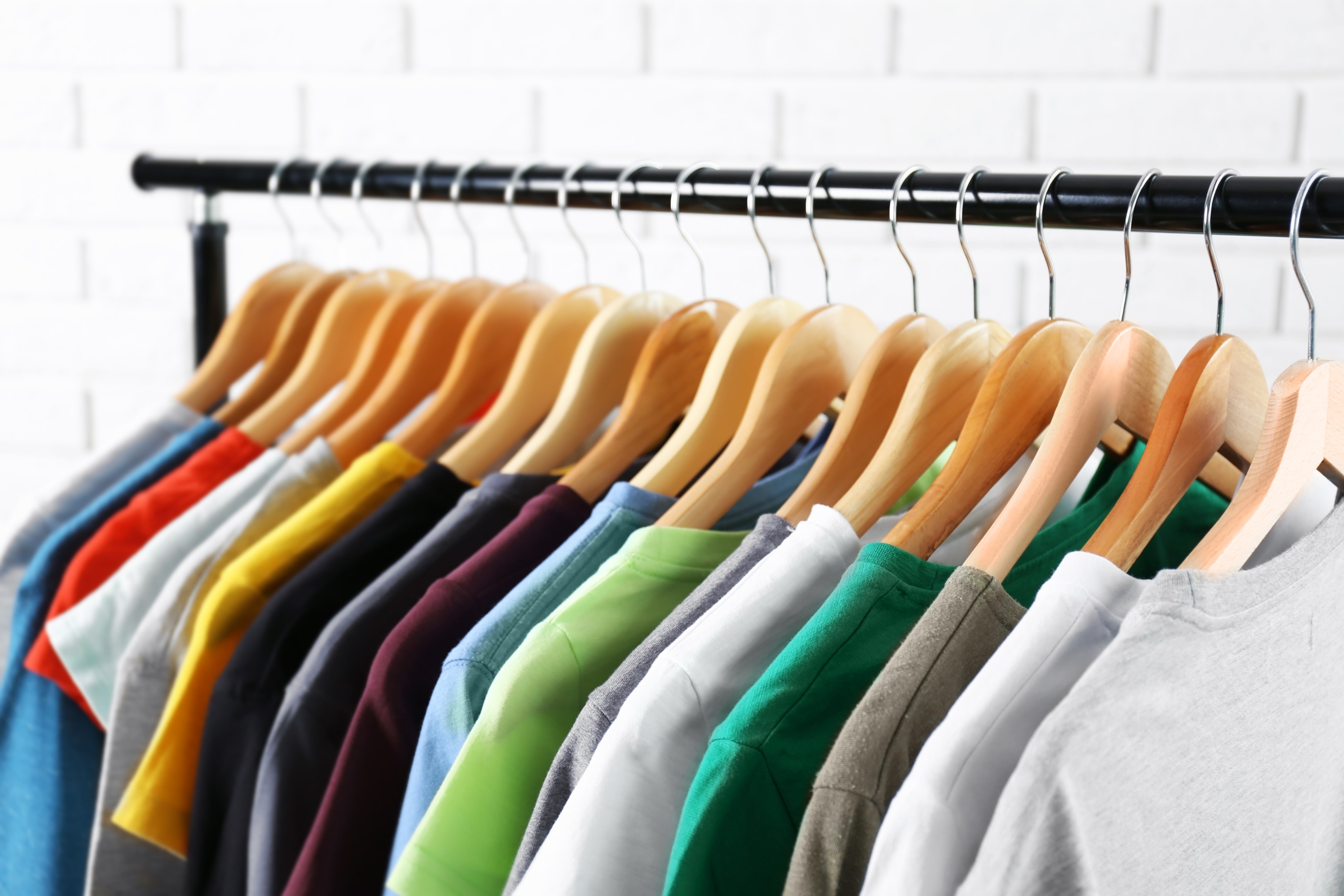 clothing rack of multi-colored t-shirts