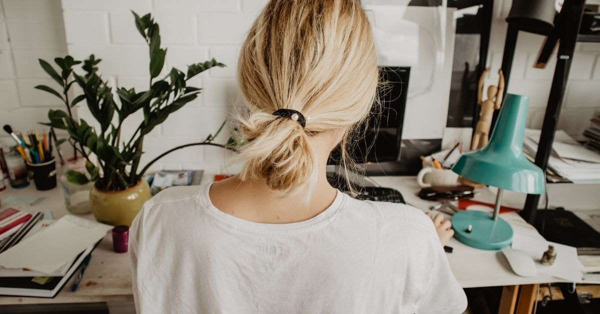 Woman sitting at desk to evaluate for tax purposes, managing her OnlyFans business finances.