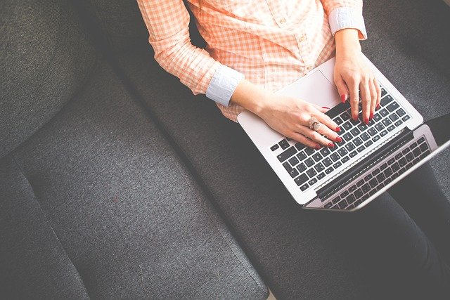 author, content creator using laptop to write new E-E-A-T articles for her blog