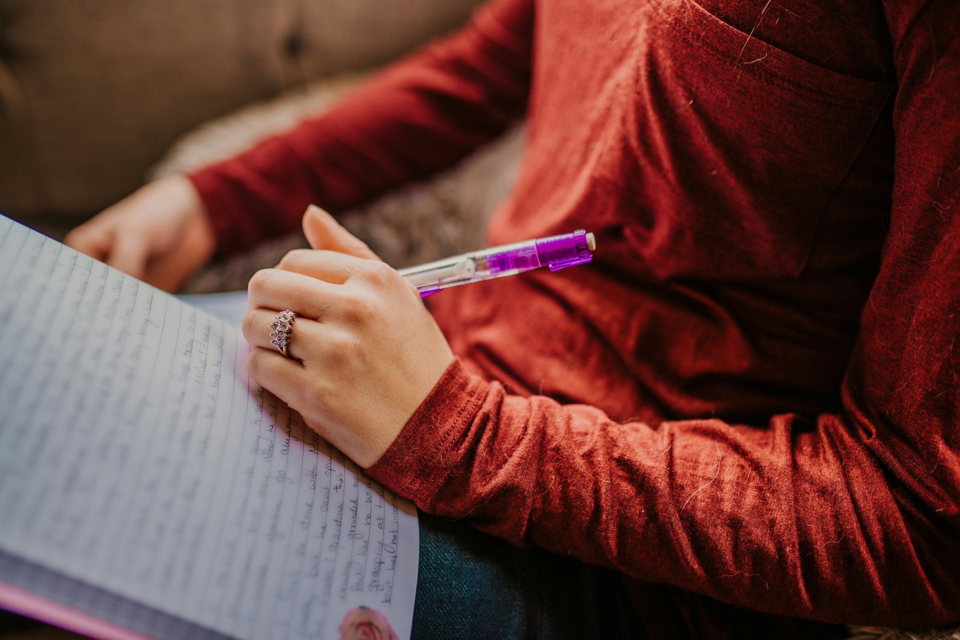 A young woman working on creating writing.