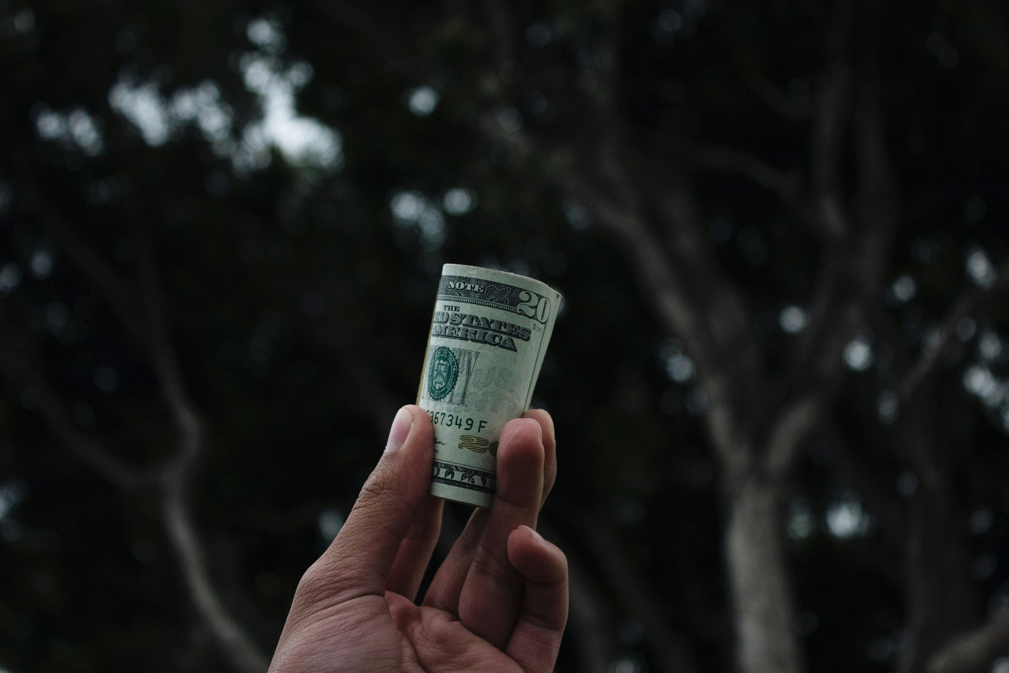 Real estate investor holds cash to represent financing for house flip.