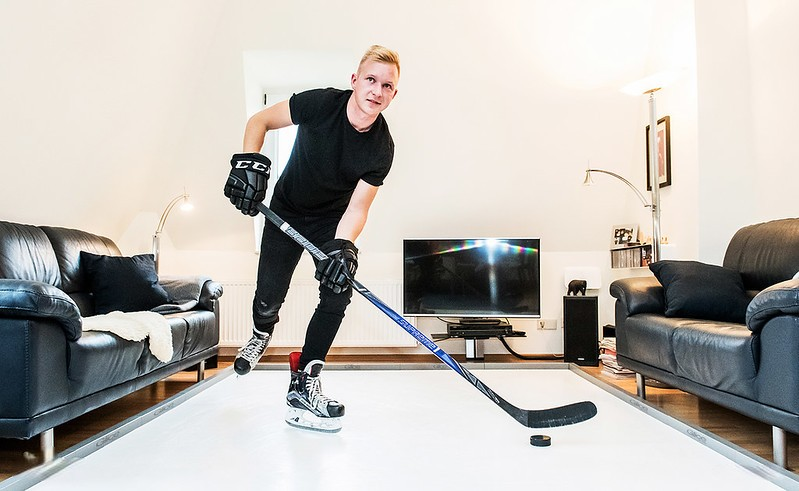 Man practicing ice hockey at home
