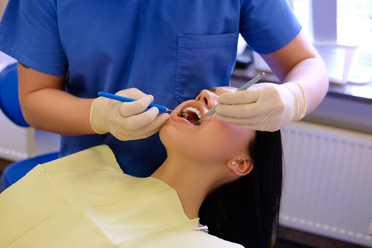 Dentist checking a patient's mouth